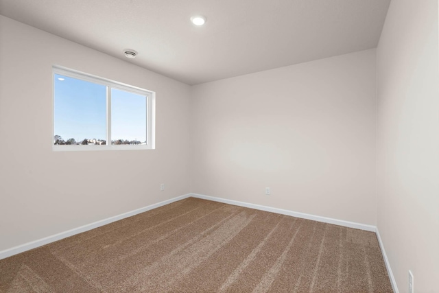 carpeted empty room with recessed lighting and baseboards