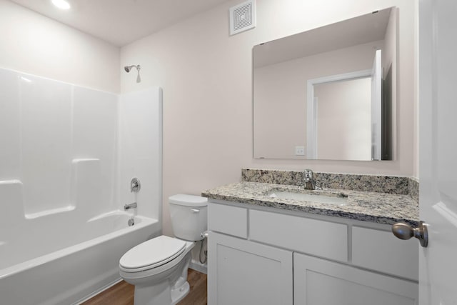 full bathroom featuring visible vents, toilet, shower / tub combination, wood finished floors, and vanity