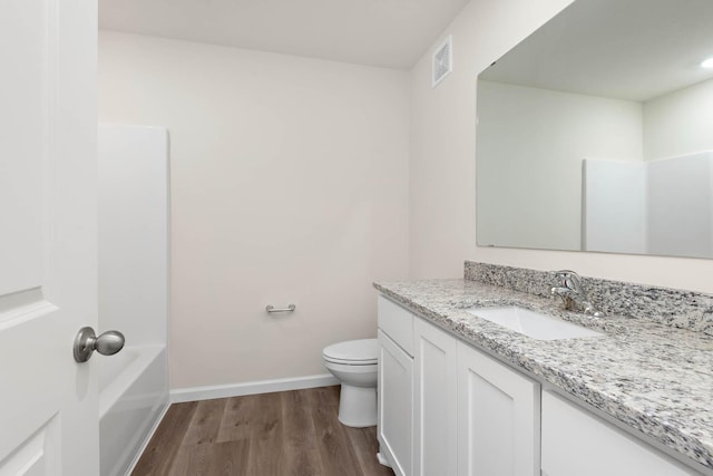 full bath with visible vents, baseboards, toilet, wood finished floors, and vanity