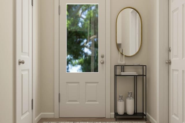 doorway to outside featuring baseboards