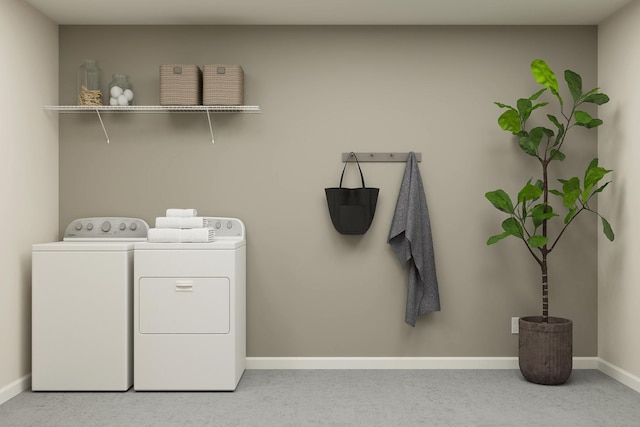 washroom featuring baseboards, separate washer and dryer, and laundry area