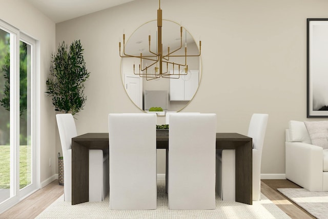 dining room featuring baseboards, an inviting chandelier, and wood finished floors