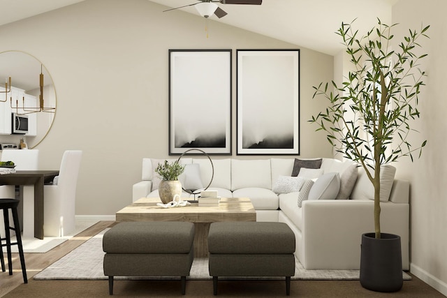 living room with a ceiling fan, lofted ceiling, wood finished floors, and baseboards