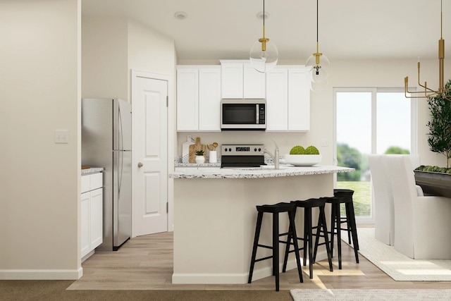 kitchen with white cabinets, plenty of natural light, light wood-style flooring, and appliances with stainless steel finishes