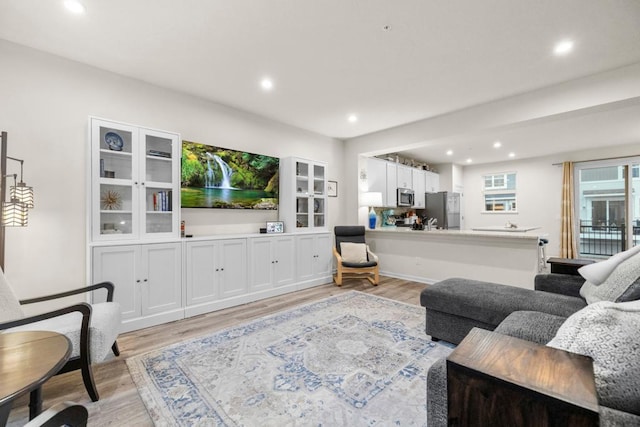 living room featuring light wood finished floors and recessed lighting