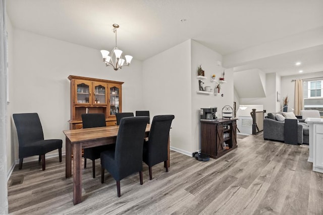 dining area featuring a chandelier, light wood-type flooring, baseboards, and recessed lighting