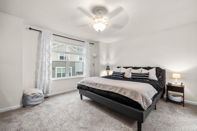 bedroom with carpet flooring, a ceiling fan, and baseboards