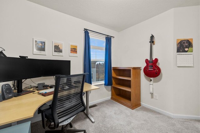 home office featuring carpet flooring, a textured ceiling, and baseboards