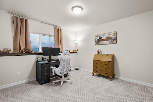 carpeted office featuring baseboards