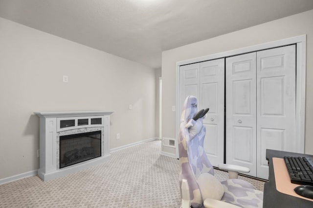 interior space with carpet, a high end fireplace, and baseboards