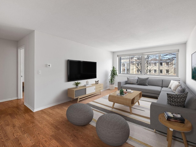 living room featuring a textured ceiling, wood finished floors, and baseboards