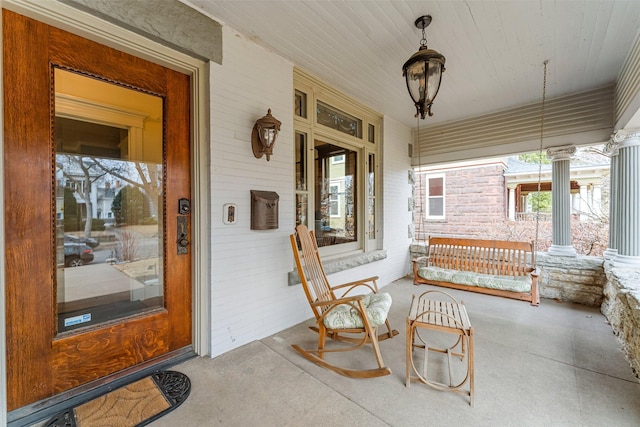 view of exterior entry featuring covered porch