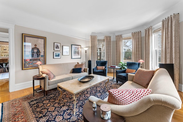 living area featuring baseboards and wood finished floors