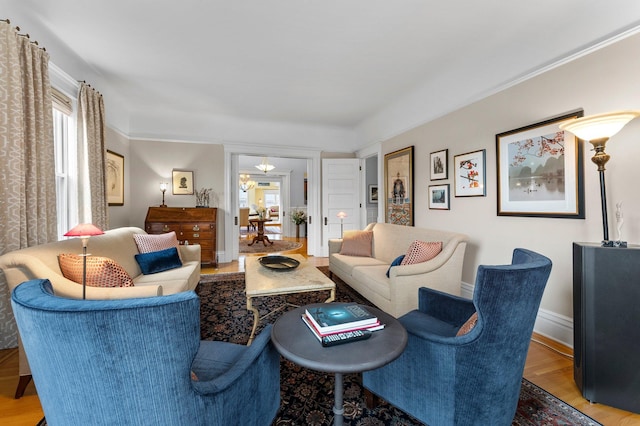 living area featuring baseboards and wood finished floors