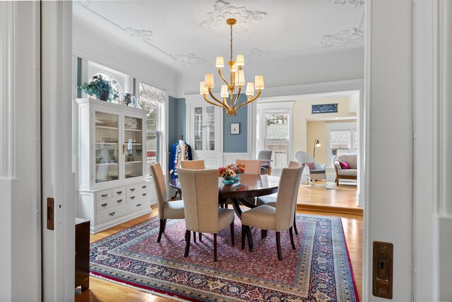 dining space featuring an inviting chandelier and wood finished floors