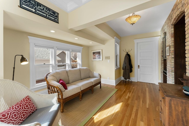 living room with recessed lighting, baseboards, and light wood-type flooring