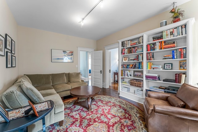 living area featuring track lighting and wood finished floors