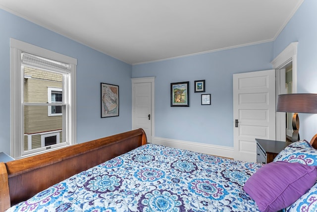 bedroom with crown molding and baseboards