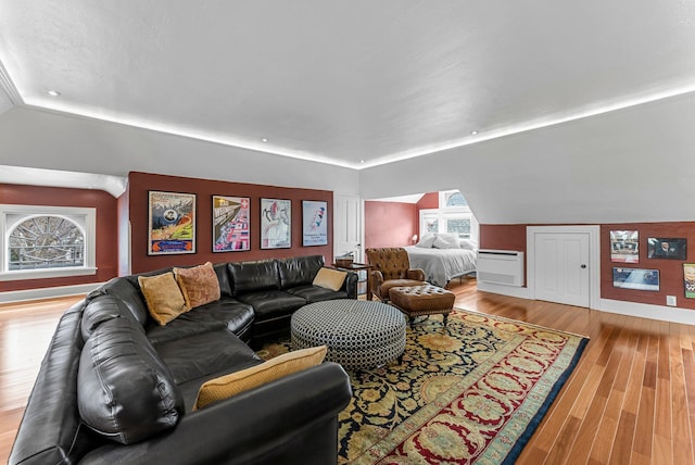 living area with lofted ceiling and wood finished floors