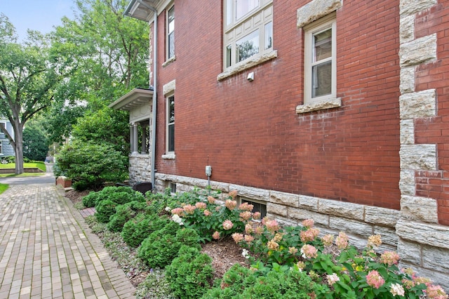 view of side of property with brick siding