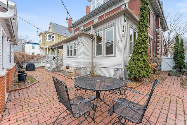 view of patio / terrace featuring a gate, outdoor dining space, and fence