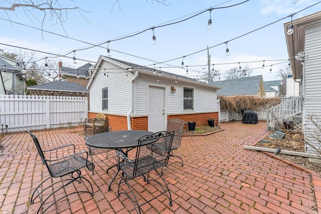 view of patio / terrace with outdoor dining space, fence, and grilling area