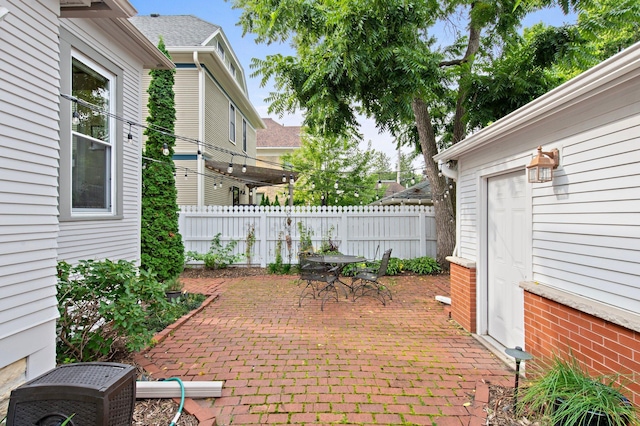 view of patio with outdoor dining space and fence