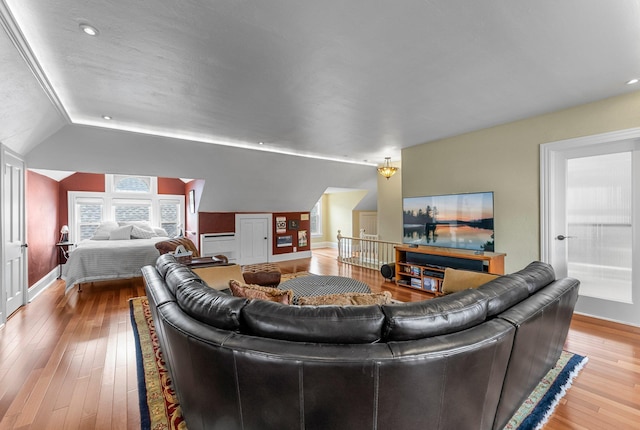 living area with wood-type flooring, vaulted ceiling, baseboards, and recessed lighting