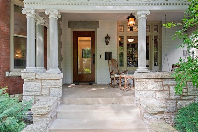 view of exterior entry featuring a porch