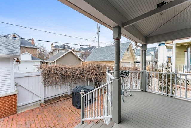 deck with a grill, fence, and a patio area
