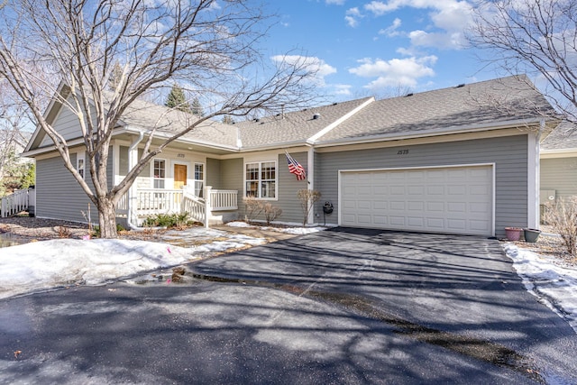 single story home featuring a porch, aphalt driveway, roof with shingles, and an attached garage