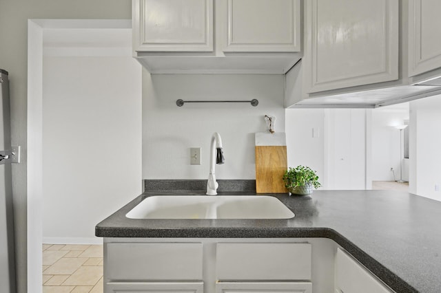 kitchen with dark countertops and a sink