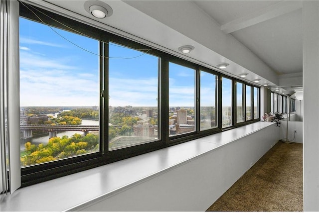 unfurnished sunroom featuring a water view and a healthy amount of sunlight