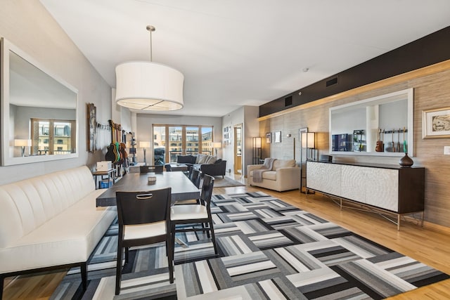 dining space featuring plenty of natural light, visible vents, and wood finished floors