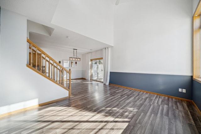 interior space with stairway, baseboards, and wood finished floors