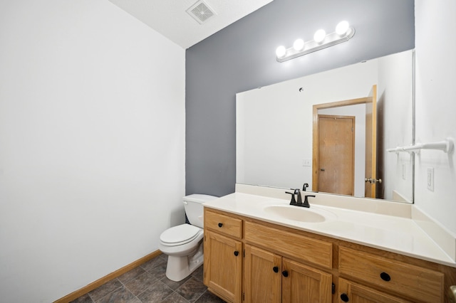 half bath featuring baseboards, visible vents, vanity, and toilet