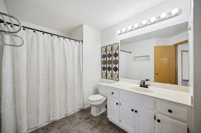 bathroom with toilet, a textured ceiling, and vanity