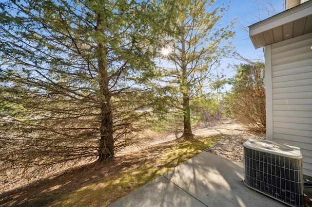 view of yard with cooling unit and a patio area