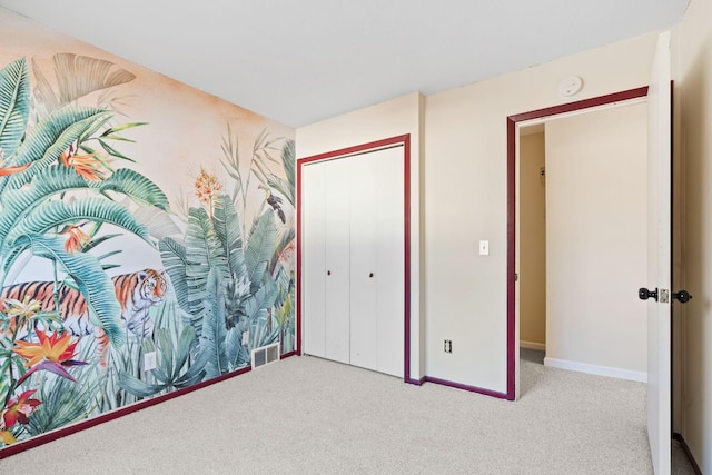 carpeted bedroom with a closet, visible vents, and baseboards