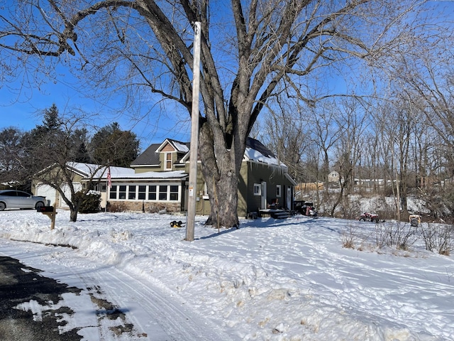 view of front facade with a garage and stone siding