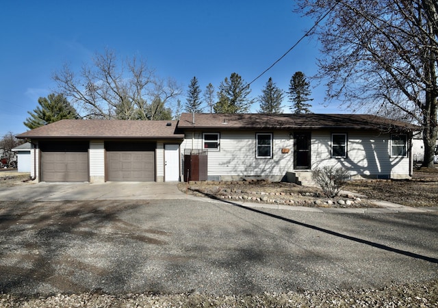 ranch-style home with an attached garage and driveway