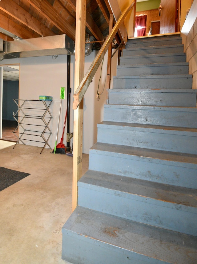 stairway with unfinished concrete flooring