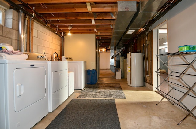 unfinished below grade area featuring concrete block wall, heating unit, washing machine and dryer, and water heater