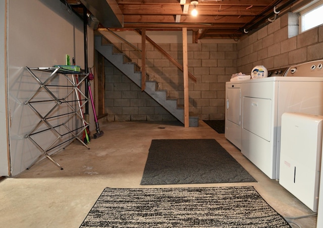 basement with stairs and washing machine and dryer