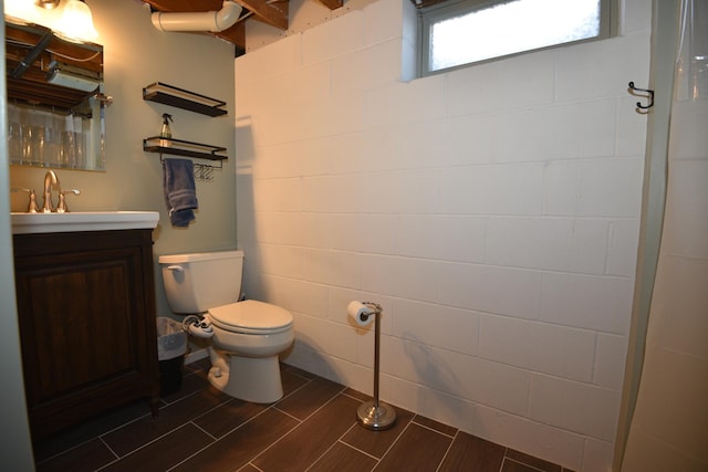 full bathroom featuring vanity, toilet, and wood tiled floor