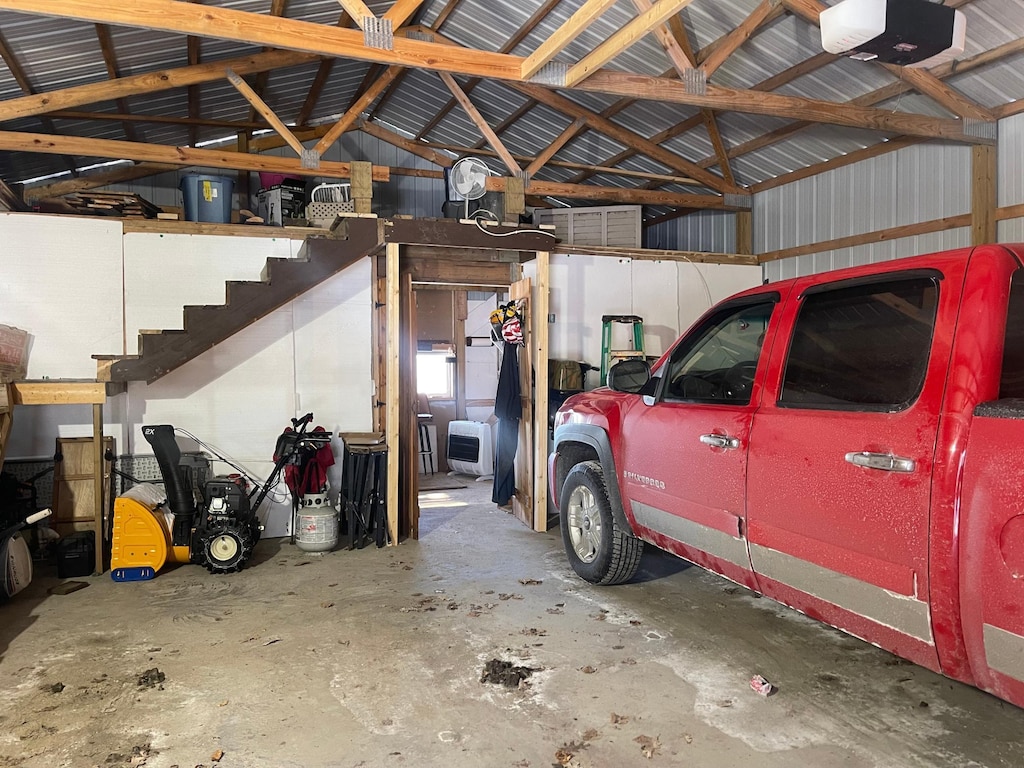 garage with metal wall and a garage door opener