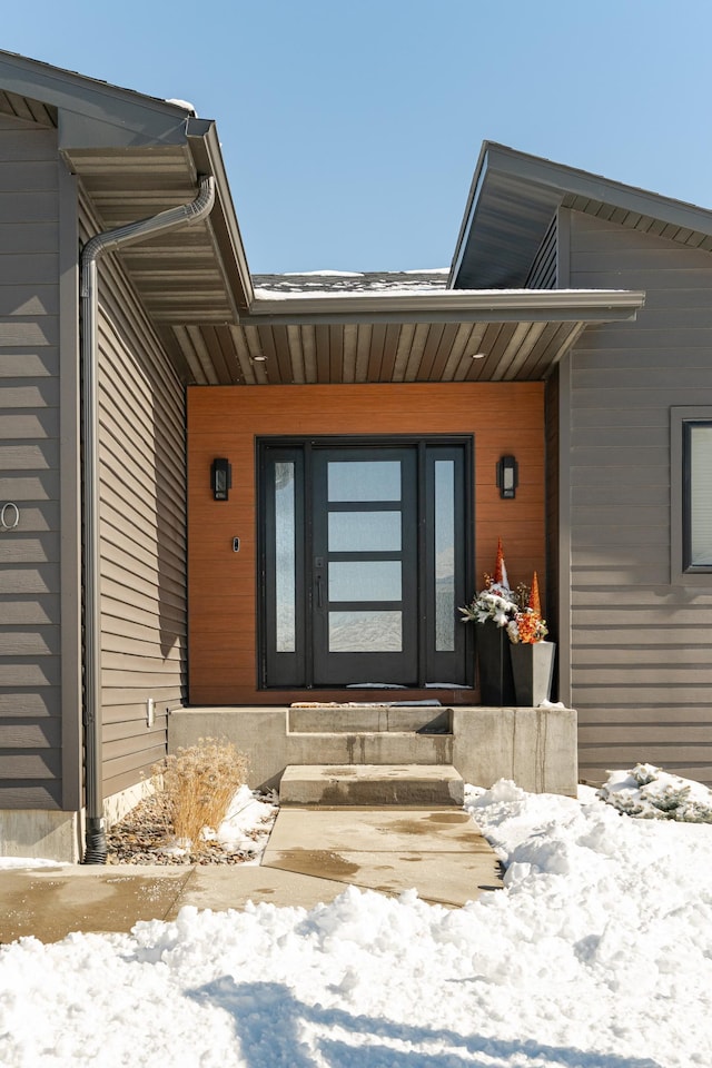 view of snow covered property entrance