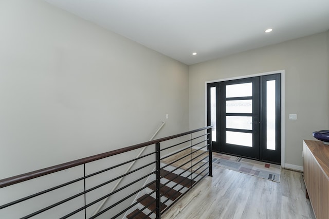 entryway featuring light wood-style floors, baseboards, and recessed lighting