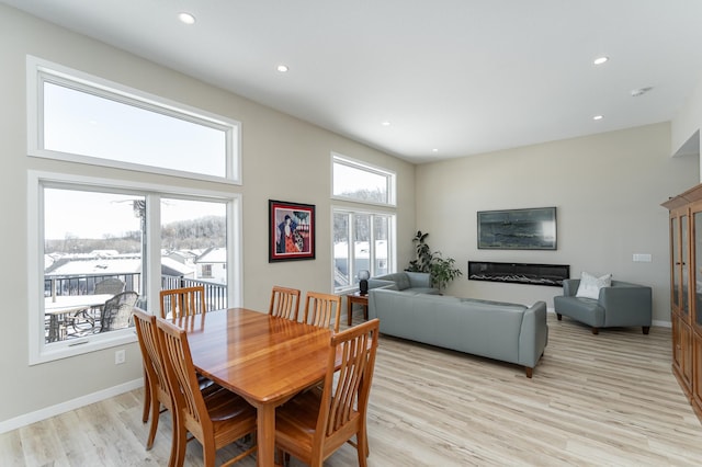 dining area with light wood-style flooring, baseboards, and recessed lighting