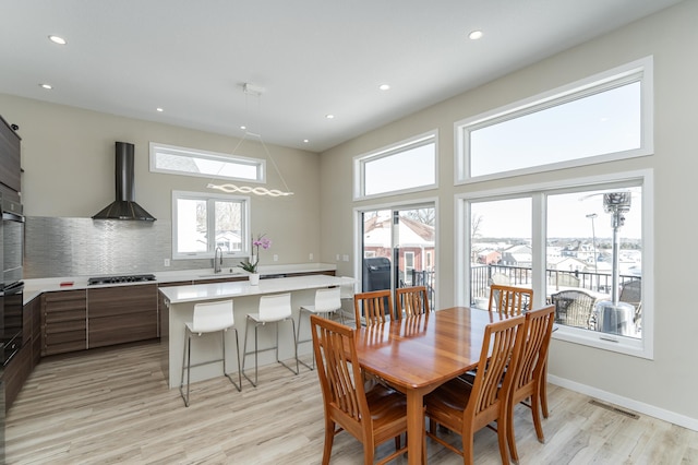 dining area with recessed lighting, visible vents, light wood-style flooring, and baseboards